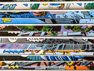 Vintage comic book collection stacked in a pile creates background pattern of colorful lines and...