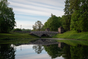 Fototapeta premium View of the White Lake in Gatchina Park and the stone bridge at the Konetable Square on a sunny summer day, Gatchina, Leningrad region, Russia