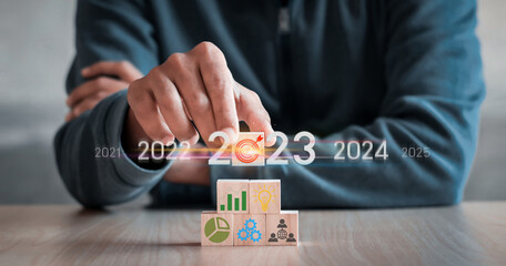 hand stack woods block step on table with icon Action plan, Goal and target, success and business target concept, project management, company strategy development. positive indicators in 2023,