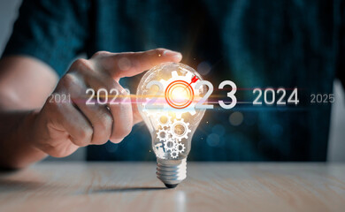 The hand of a man with a light bulb. The idea of ​​inspiration from online...