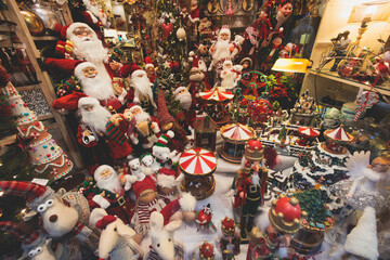 Christmas market details with New Year decorations and multicolored flags, garlands and festoons, Xmas atmosphere, fair interior, retail and store with illumination, New Year glowing decor