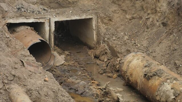 Laying heating pipes in trench at construction site. Heating system of apartments in city house