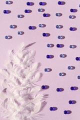 white tree with feather and crystal on purple backgroumnd