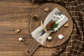 Fototapeta na wymiar Festive dinner table setting spoon, fork knife, christmas decorations. Christmas concept.