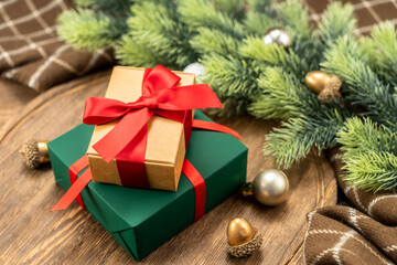 Christmas present on wooden cutting board with Christmas decorations.