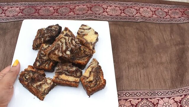 cake-platepresenting Healthy and Homemade freshly baked Marble fruit cake in white plate for Christmas or other important occation. Brown background.	
