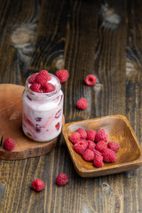 Milk yogurt with raspberries, close up