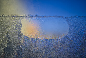 Iridescent glow as the sun strikes a layer of ice or frost