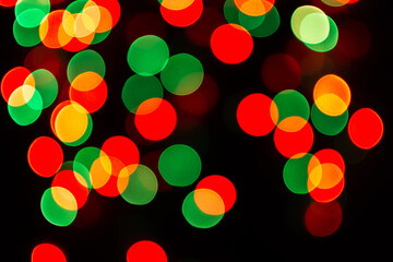 Christmas defocused lights, blurred colorful lights on a dark background, festive background