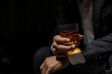 Closeup businessmen holding a glass of whiskey