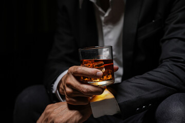 Closeup businessmen holding a glass of whiskey