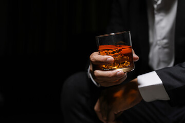 Closeup businessmen holding a glass of whiskey