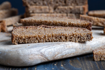 sliced rye bread on a wooden table, close up