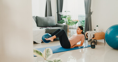 Young attractive sporty Asia strong woman in sportswear with calm feeling warming up stretching...