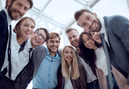 Close Up. Group Of Smiling Young People Looking At The Camera .