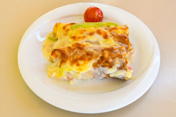 Turkish style meat stuffed filo dough borek served kol boregi. Cheese and minced pie are sliced on a marble background. Turkish name: Kol Boregi, kiymali, peynirli su boregi.