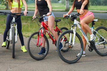 cropped image of group of women sitting on bikes.