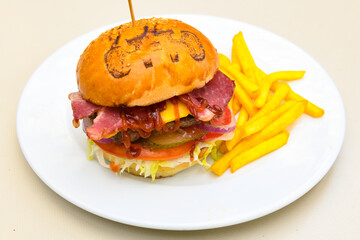 Big tasty burger with beef cutlet on a plate