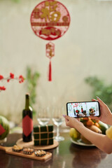 Woman Photographing Food Served for Tet