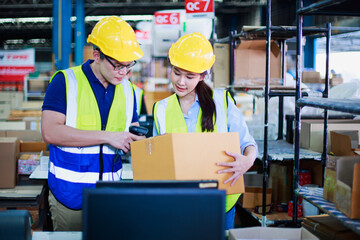 Female, male worker holding barcode scanner with scanning on package box in building construction material store manufacturing warehouse , import export shipping logistics industrial transportation.