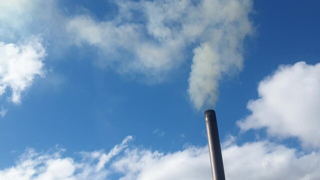 smoke from a chimney against the sky, heating of a cottage with coal, environmental pollution and energy crisis