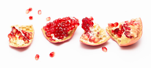 Juicy pomegranate berries isolated on white background.