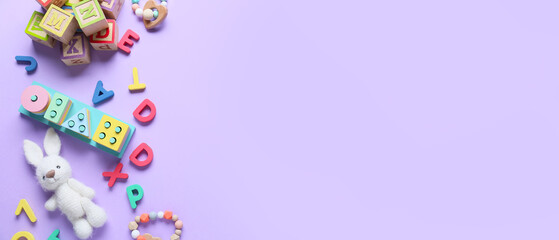 Set of children's toys on lilac background with space for text