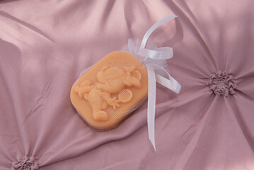 a children's soap wrapped in white lace