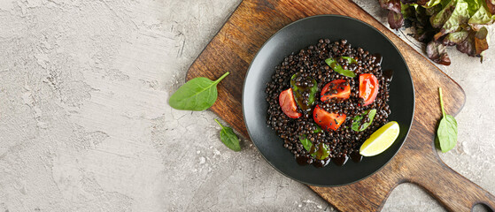 Plate with tasty cooked lentils and vegetables on grunge background with space for text