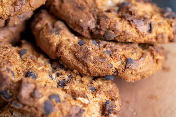 Delicious cookies with pieces of chocolate on the table