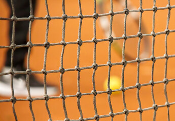 Tennis net on red clay closed tennis court