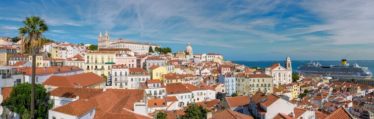 Fototapeta na wymiar Panoramic view of Lisbon Portugal with red roofs, palaces, port with ships