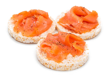 Naklejka na ściany i meble Tasty Rice Cake Sandwiches with Fresh Salmon Slices Isolated on White. Easy Breakfast and Diet Food. Crispbread with Red Fish. Healthy Dietary Snacks - Isolation