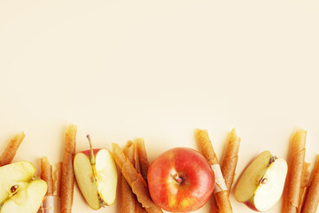 Fresh apples and tasty fruit pastilles on color background