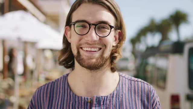 Summer, travel and face of man in Miami enjoying holiday, weekend getaway and vacation standing in city street. Fashion, relax and portrait of male with smile for adventure, freedom and spring break