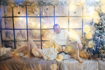 Obraz na płótnie Canvas couple in love in new year interior studio
