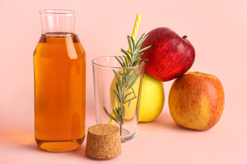 Ripe apples, bottle of fresh juice and glass with rosemary on color background
