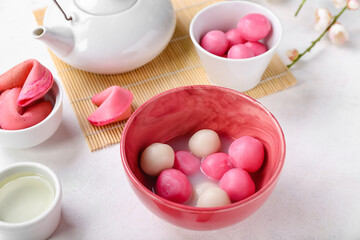 Bowls of tasty tangyuan on white background, closeup. Dongzhi Festival