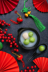 Bowl of tangyuan and Chinese decor on dark background. Dongzhi Festival