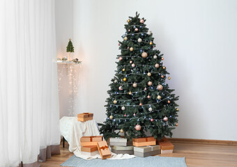 Beautiful Christmas tree with presents and pouf in living room