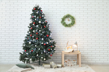 Interior of living room with glowing Christmas tree, wreath and table