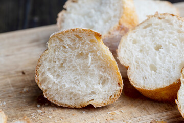 Sliced wheat baguette on a board