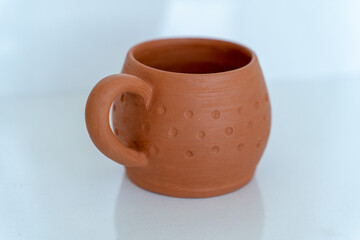 Ceramics, a ceramic product made with their own hands on a potter's wheel, a mug.