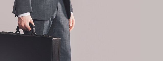 Corporate businessman holding a briefcase