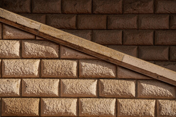 Brick vintage textured wall with diagonal shapes in an abstract photo great for background. Lights and shadows.