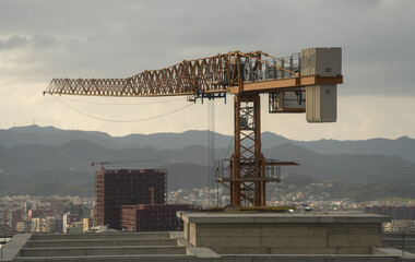 Construction industry in Albania. A crane is used to build a new modern office in Tirana, tall...