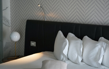 Detail view of a hotel room in white and grey shades color and texture. Premium luxury interior details.