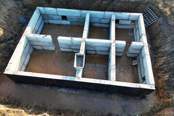 Construction of the foundation of the building from concrete blocks. view from above. drone photography. Prefabricated foundation of reinforced concrete blocks.