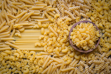 Raw pasta various kinds of uncooked pasta macaroni spaghetti and noodles, Italian food culinary concept, Collection of different raw pasta on cooking table for cooking food