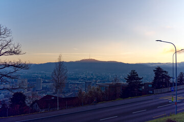 Aerial view over city of Z&uuml;rich with local mountain Uetliberg in the background and bright sunlight and beautiful autumn evening sun. Photo taken December 6th, 2022, Zurich, Switzerland.